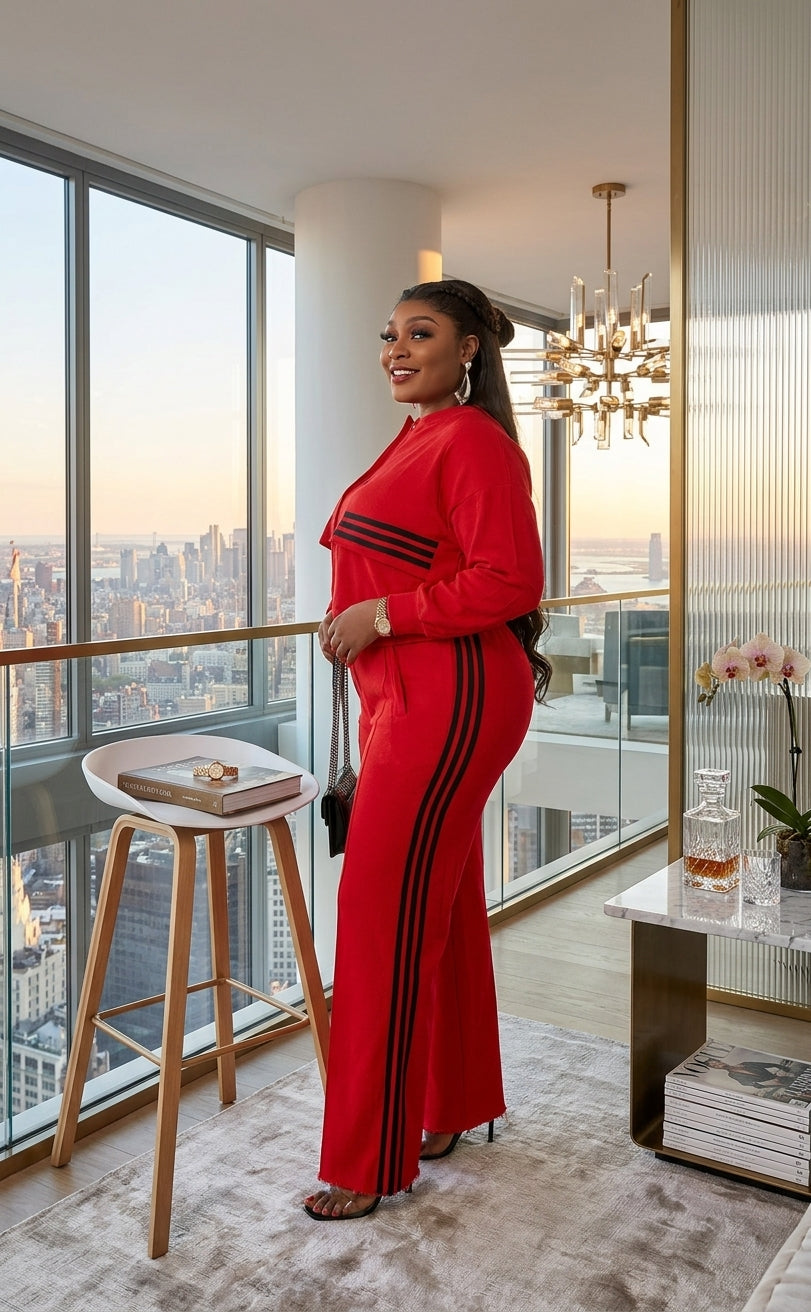 Vibrant red two-piece suit with long sleeves, styled for special occasions and evening events.