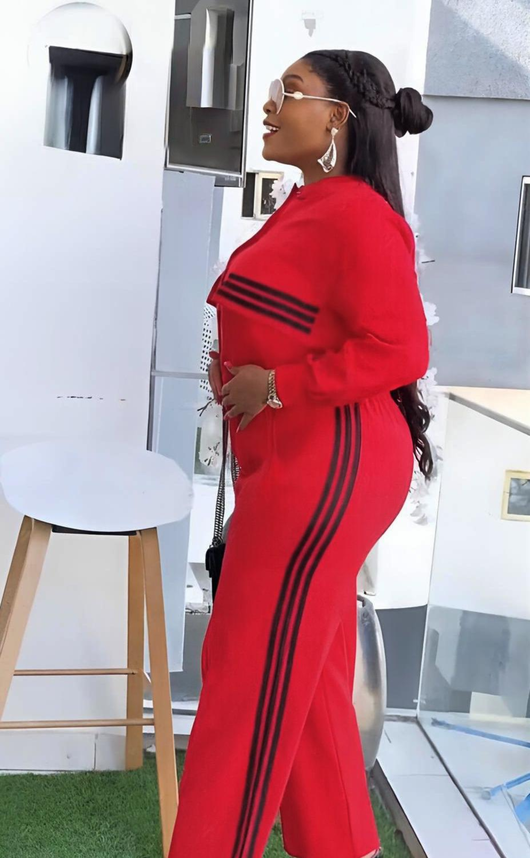 Person wearing a red outfit with black stripes in an outdoor setting.