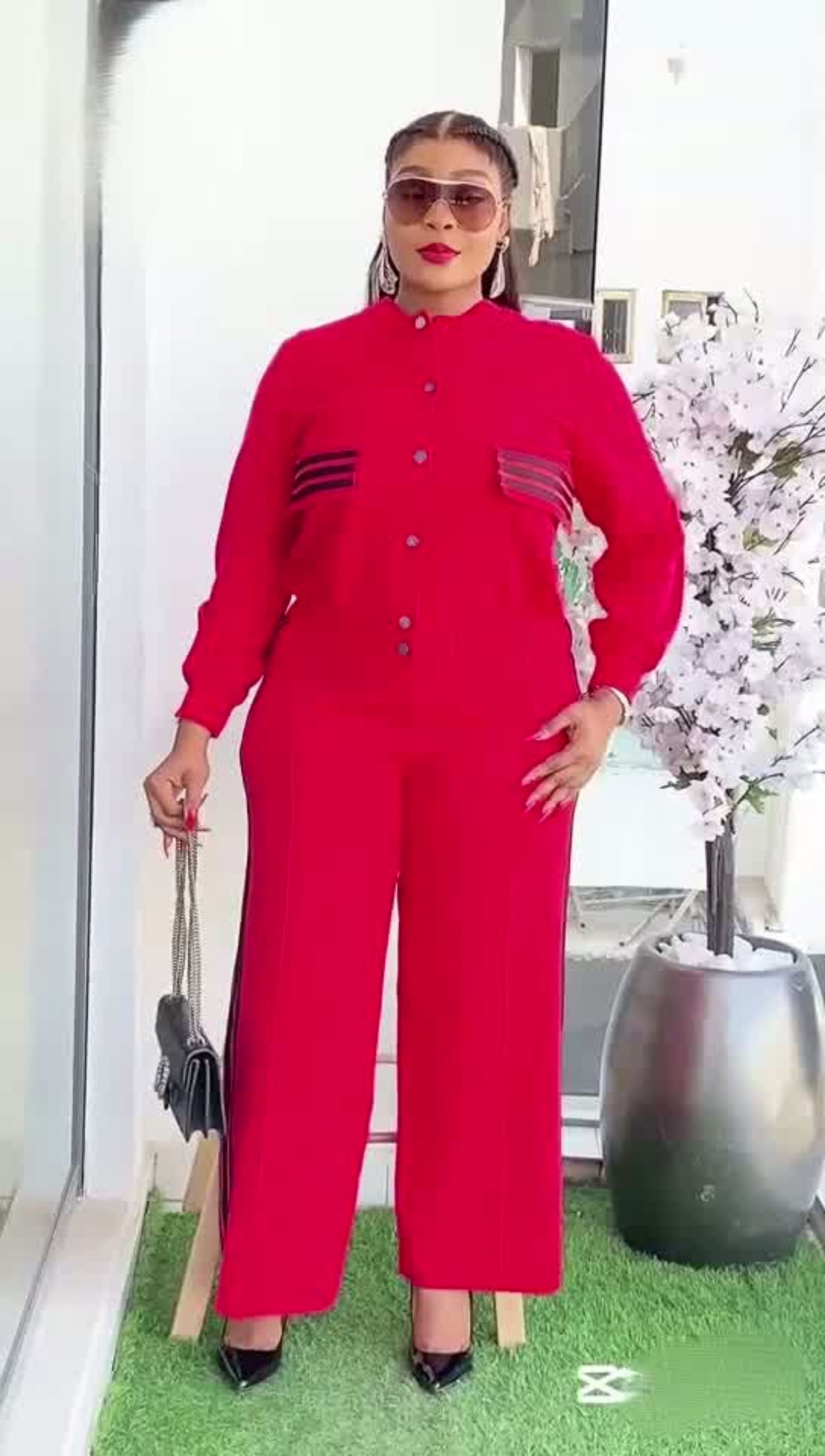 Person wearing a red outfit with sunglasses indoors