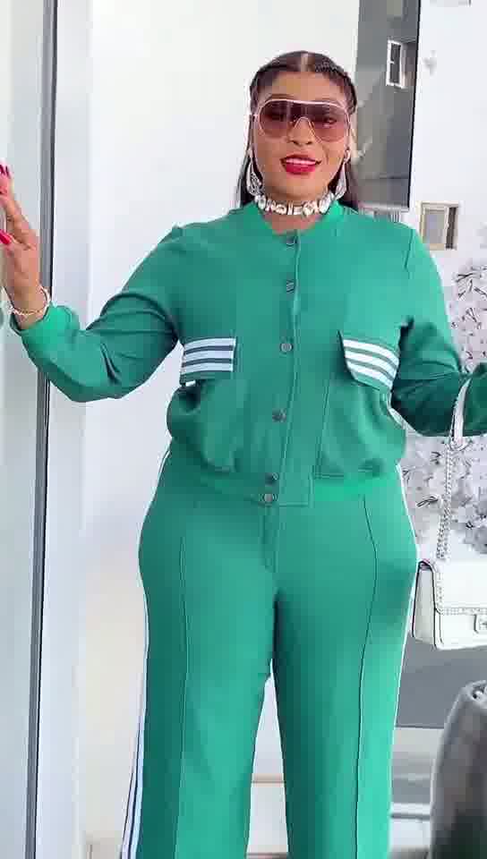 Person wearing a green outfit with white stripes in an indoor setting